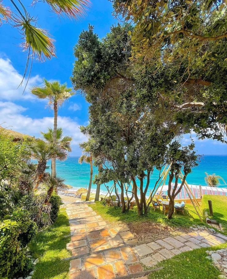 Clear turquoise water and beach bars along Batroun's coastline