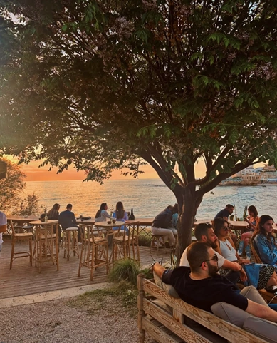Sunset crowd at a bar overlooking the sea in Batroun, Lebanon