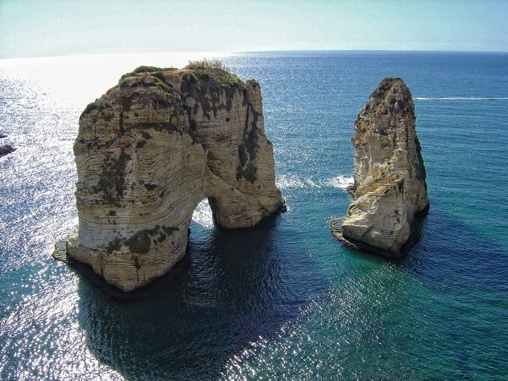 Raouché Rock in Beirut Lebanon with waves hitting the Mediterranean cliffs