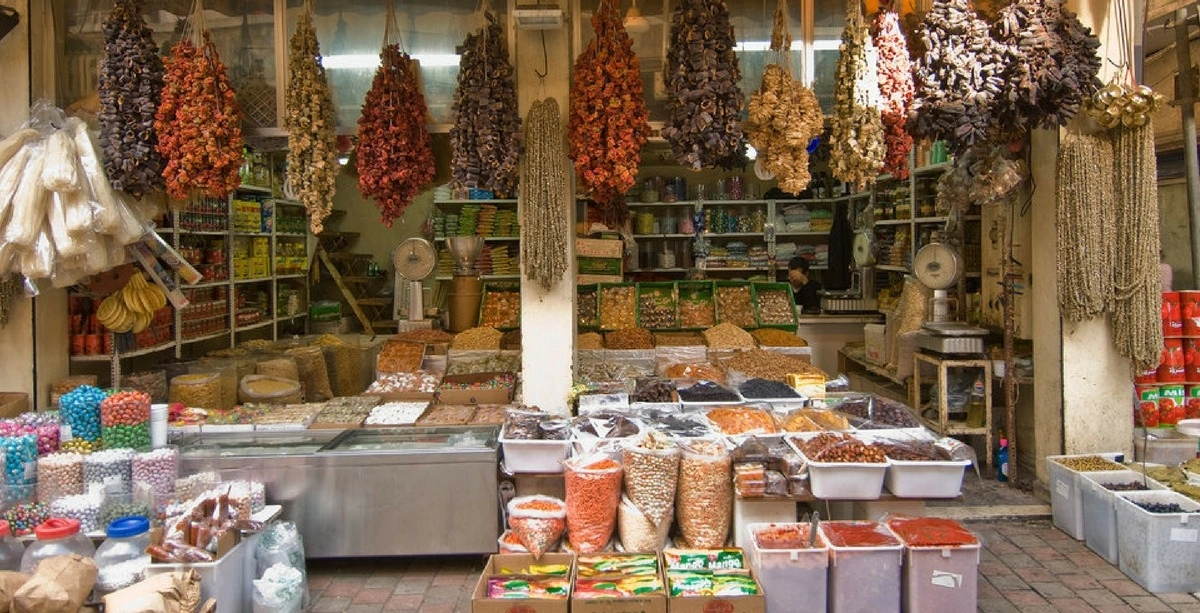 Traditional spice and dried goods shop in Bourj Hammoud, Metn, with colorful spices, herbs, nuts, and hanging dried produce displayed along the storefront