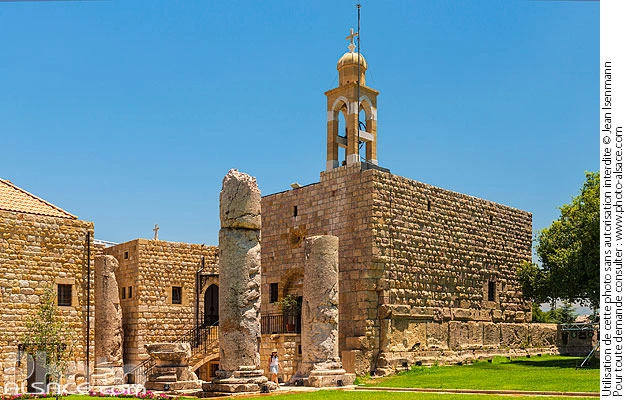 Ancient stone church and Roman columns at Deir El Qalaa Monastery in Beit Mery, overlooking the pine-covered hills of Metn