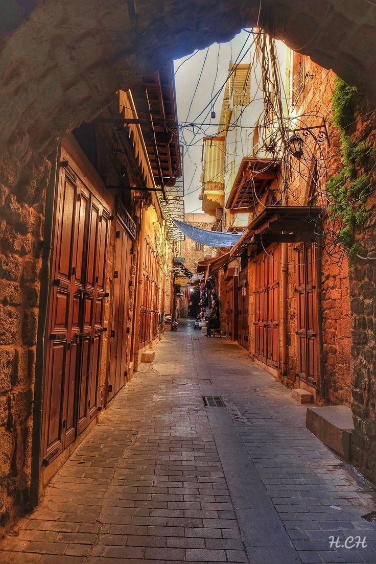 Narrow stone alley with colorful shops in Sidon old souks, Lebanon