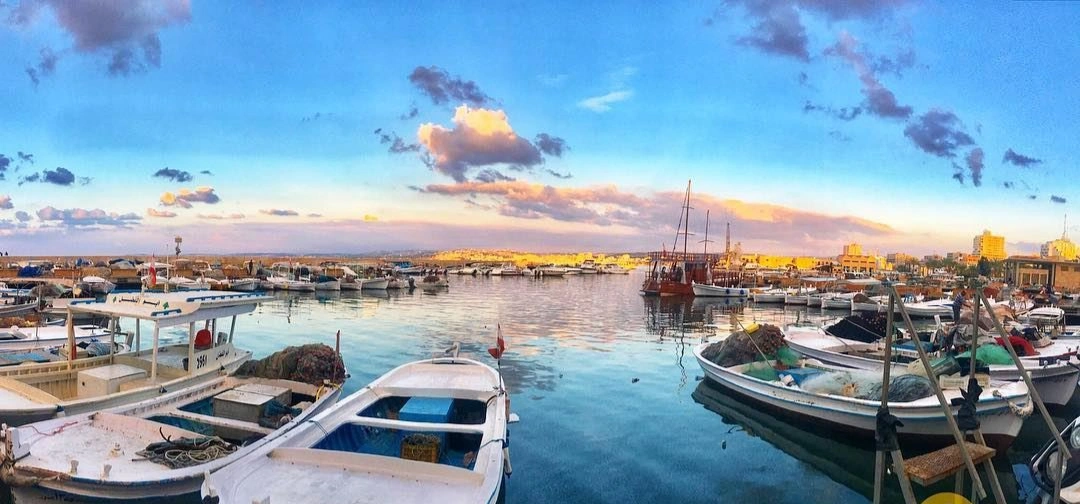 Fishing boats and stone Ottoman houses along Tyre's old harbor