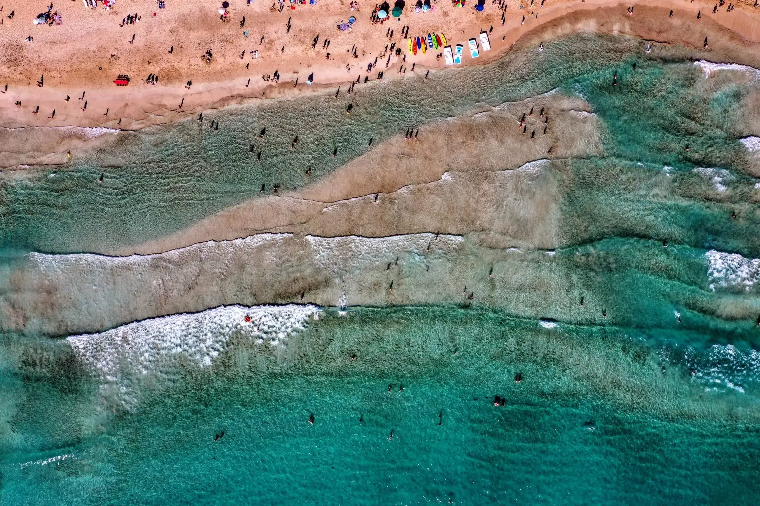 Wide sandy coastline and turquoise water at Tyre public beach in southern Lebanon