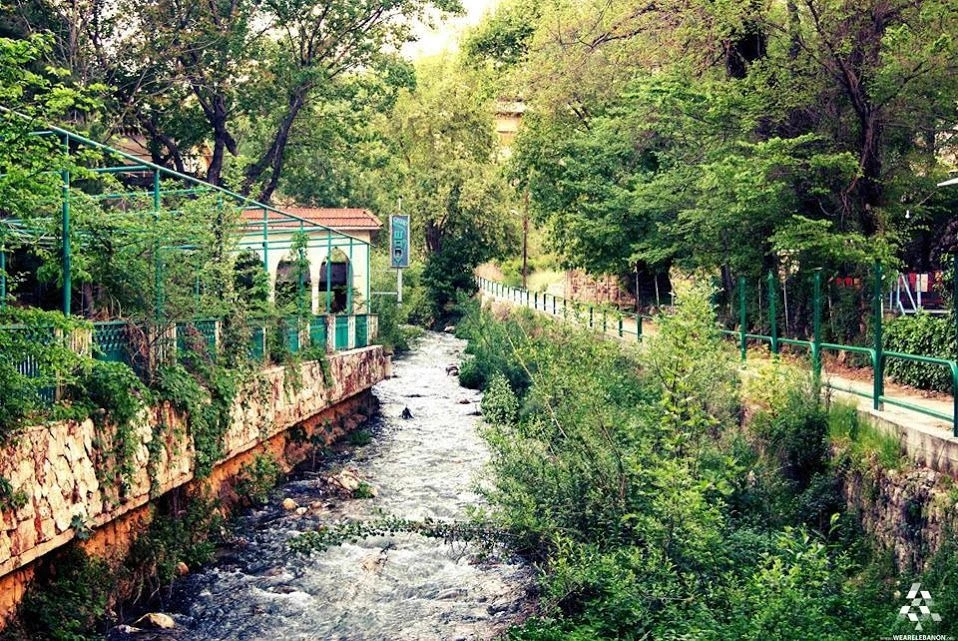 Bardawni River lined with open-air restaurants and green trees in Zahlé, Lebanon